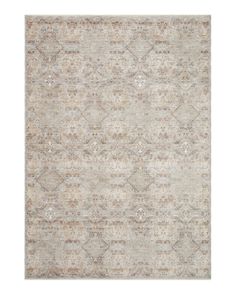 an area rug with various colors and patterns on the floor, including beiges and browns