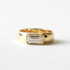 a gold ring with a baguette cut diamond