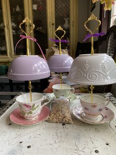 teacups and saucers are sitting on a table