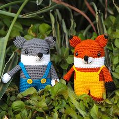 two crocheted stuffed animals are sitting in the grass and some plants with green leaves