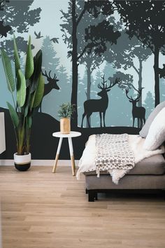 a living room with a couch, chair and deer mural on the wall behind it