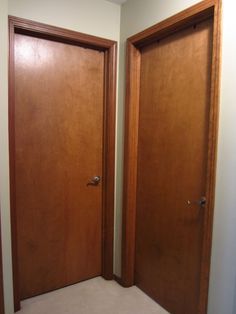 two wooden doors are open in an empty room with carpeting on the floor and walls