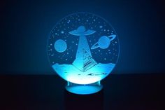 an illuminated glass globe with space and planets on it