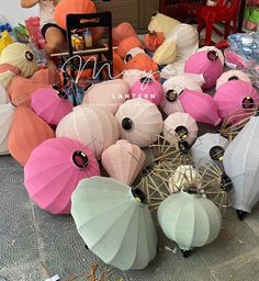 there are many different colored umbrellas on the ground and in front of each other