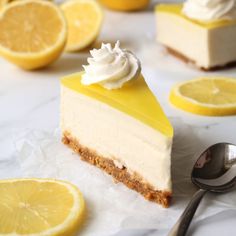 a slice of lemon cheesecake with whipped cream and sliced lemons in the background