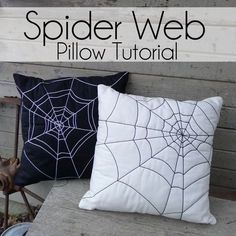 two spider web pillows sitting on top of a wooden bench