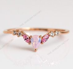 The sweetest stacker.  With its pink opal and light pink CZ's, we especially love the Sweet Like Honey Ring paired with  opal to create a pastel dream stack.Natural Pink Opal Ring, Vintage Opal Band, Opal Wedding Band, Rose Gold Opal Ring, Dainty Opal Ring, October Birthstone, Matching Band Ring Item Details Metal: 925 Sterling Silver Main stone creation-Opal  (lab created) Main Stone Color: Pink Main Stone Shape: Pear Cutting technique-  Cut Theme: Dainty, Statement & Engagement Method: handmade Personalization: Possible Occasion: Wedding ring, engagement ring, birthday ring, ring for her, proposal ring Style: Ring Size: We make rings from US 4 to US 15. (If you need smaller or bigger ring size, please ask me to resize) Country of Manufacture: India All our work is custom made by hand wit Eclectic Rings, Wedding Rings Boho, Cute Promise Rings, Sweet Like Honey, Pink Opal Ring, Opal Ring Vintage, Angel Ring, Gold Opal Ring, Rose Gold Opal Ring