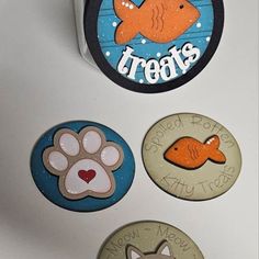 four magnets with dogs and fish on them