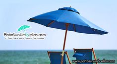 two beach chairs under an umbrella on the beach