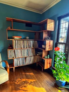 an old record player is in the corner of a room with blue walls and wooden floors