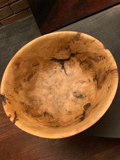 a wooden bowl sitting on top of a table