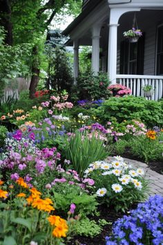 colorful flower garden in front of a house