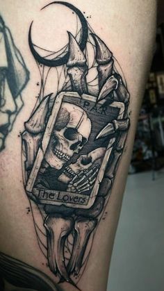 a black and white tattoo with a skull on it