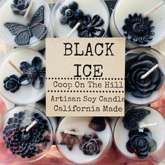 black ice candles are arranged in a display case with a sign that says,'soap on the hill artisan soy candle california made '