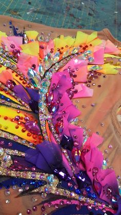 the colorful headdress is being made with sequins