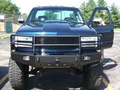 a blue pick up truck parked in a parking lot