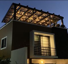 a house with lights on the roof and balcony