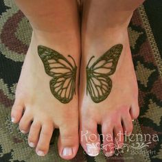 two feet with tattoos on them and one has a butterfly tattoo on the top of it