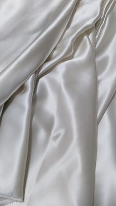 the white sheets are folded up on top of each other in this close - up photo