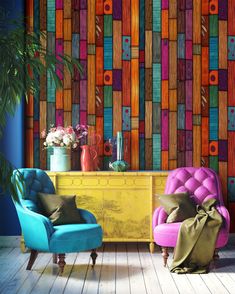 two colorful chairs sitting next to each other in front of a wall with different colored tiles on it