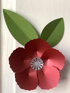 a paper flower is hanging on the wall