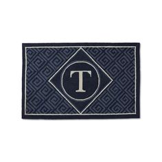 a blue door mat with the letter t on it and a diamond in the center