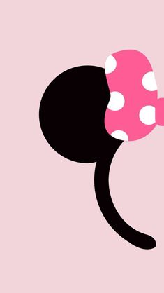 a pink and black minnie mouse with polka dots on it's head, standing in front of a pink background