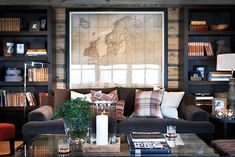 a living room filled with furniture and bookshelves