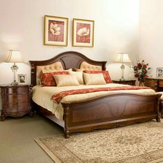 a large bed sitting next to two lamps on either side of a dresser in a bedroom