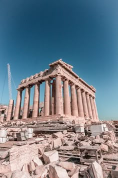 the ruins of an ancient greek temple against a blue sky