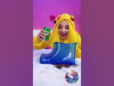 a woman dressed as pikachu holding a can in her hand and sitting on the ground