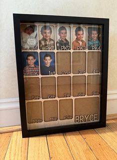 a framed photo with the names and pictures of people in it on a wooden floor