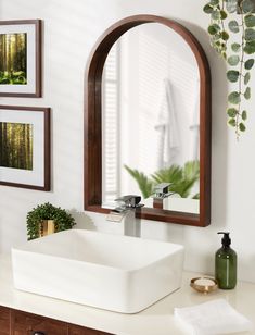 a bathroom sink sitting under a large mirror