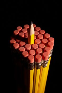 pencils are arranged in the shape of a heart on a black background stock photo