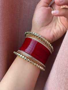 a woman's arm with three bracelets on it