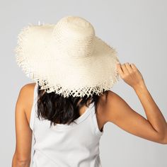 Frayed edges are a classic way to show off your personality without compromising a natural aesthetic. Featuring a 4.5" brim and classic round crown, this hat is perfect for warm weather outings to the beach, park, or pool. 100% straw 4.5" brim Women's One Size Adjustable Summer Hats With Curved Brim For Sunbathing, Beachy Fedora Hat For Sunbathing, Lightweight Beachy Panama Fedora Hat, Lightweight Hats With Curved Brim For Sunbathing, Lightweight Curved Brim Hat For Sunbathing, Beachy Sun Hat, One Size Fits Most, Beachy Panama Hat With Uv Protection And Curved Brim, Lightweight Coastal Hat For Vacation, Cream Panama Hat With Curved Brim For Vacation