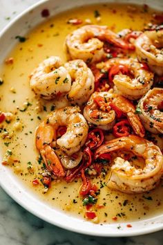 a white bowl filled with shrimp and sauce