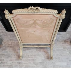 an old fashioned fireplace surround with tile flooring