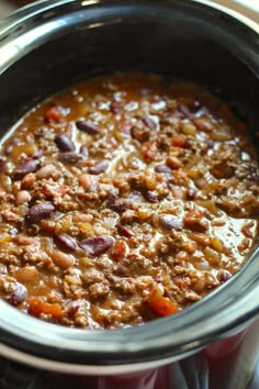 a pot filled with chili and meat on top of a stove