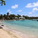 a beach with boats in the water