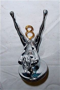 a glass figurine with a gold and silver number 8 on it's head