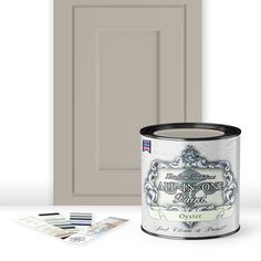 an open paint can next to the door and some other items that have been placed in front of it