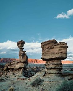 two large rocks in the middle of a desert