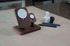 a wooden stand with a magnifying glass on it and some pens next to it