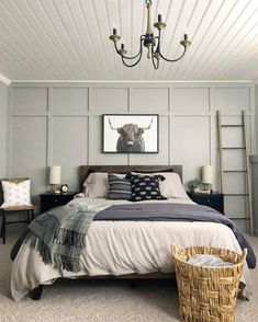 a bedroom with a large bed and a chandelier hanging from it's ceiling