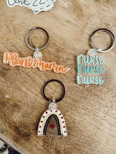 three keychains with the words, naminara, nurse nurse and nurse on them