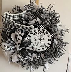 a black and white wreath that says, my dogs are not spoiled i am just well loved