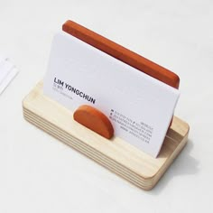 a business card holder with two hotdogs on the front and one sausage on the back