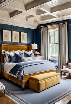 a large bedroom with blue walls and white trimmings on the ceiling, along with an upholstered bed