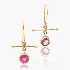 Mix Matched faceted round tourmalines, one a brighter pink than the other, encased in 18K gold with 18K gold ear wire. These are a great casual everyday pair.  Add some color to your wardrobe with these one of a kind Pink Tourmaline Gold Earrings. The bright pink hues of the faceted round tourmalines will add a playful touch to any outfit.  Measure: 1"L x .75W Although  18K gold can weather many things, it is the stones that need protecting.  Please do not wear these in the shower, swi Yellow Gold Tourmaline Gemstone Earrings, Round Tourmaline Gemstone Earrings, Gold Pink Sapphire Earrings Fine Jewelry, Gold Pink Sapphire Earrings In Fine Jewelry Style, Fine Jewelry Yellow Gold Tourmaline Earrings, Yellow Gold Tourmaline Fine Jewelry Earrings, Yellow Gold Tourmaline Drop Earrings, August Birthstone Jewelry, July Birthstone Jewelry